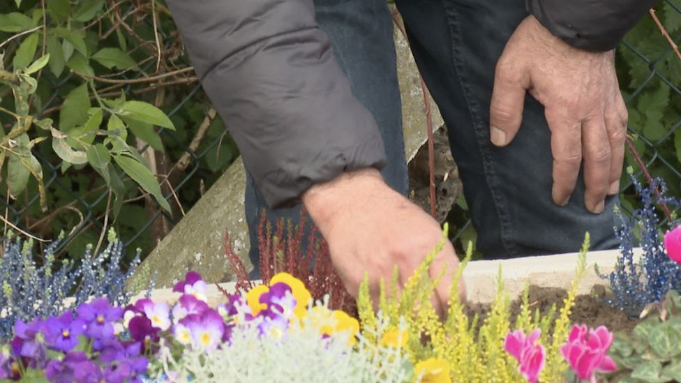 Bassam hands at flower bed