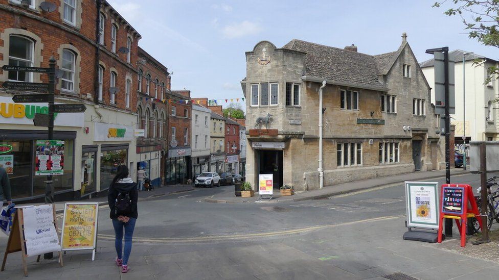 Woman standing in Stroud town centre - a Subway is to the left