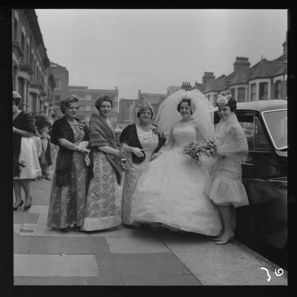 A bride about to get into the wedding car