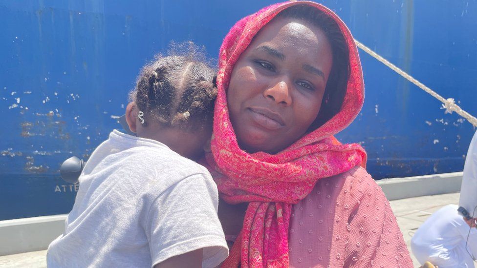 Sudanese evacuee Rasha with her young child