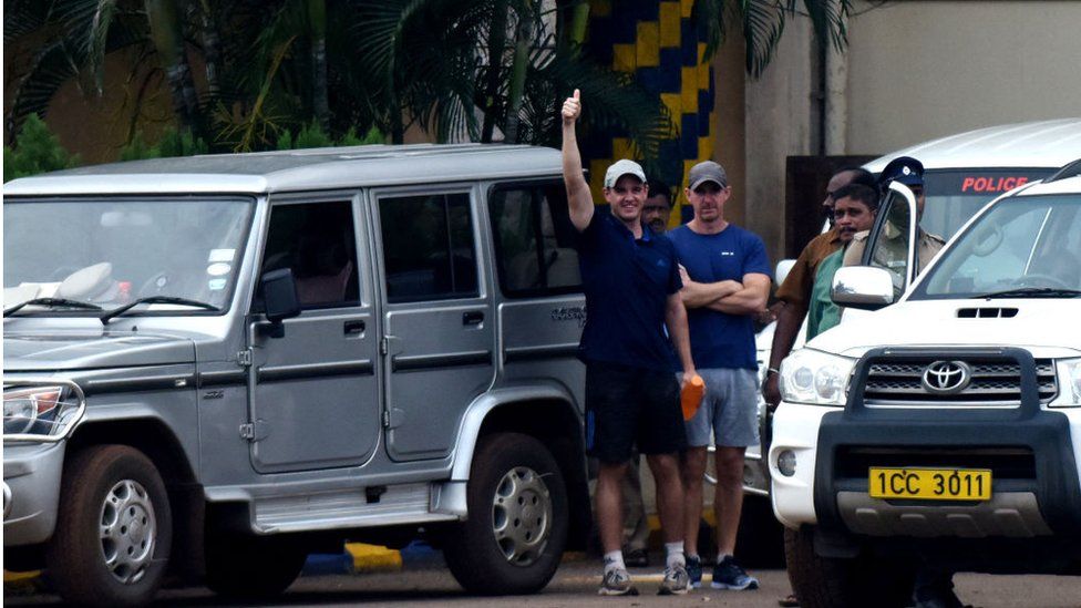 British anti-piracy crew member John Armstrong (L) gestures next to colleague Nick Simpson as they leave prison in Chennai