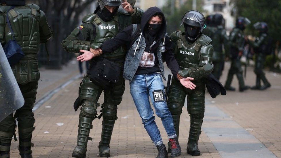 A demonstrator is detained by police officers during a protest at Bolivar Square in Bogota, Colombia