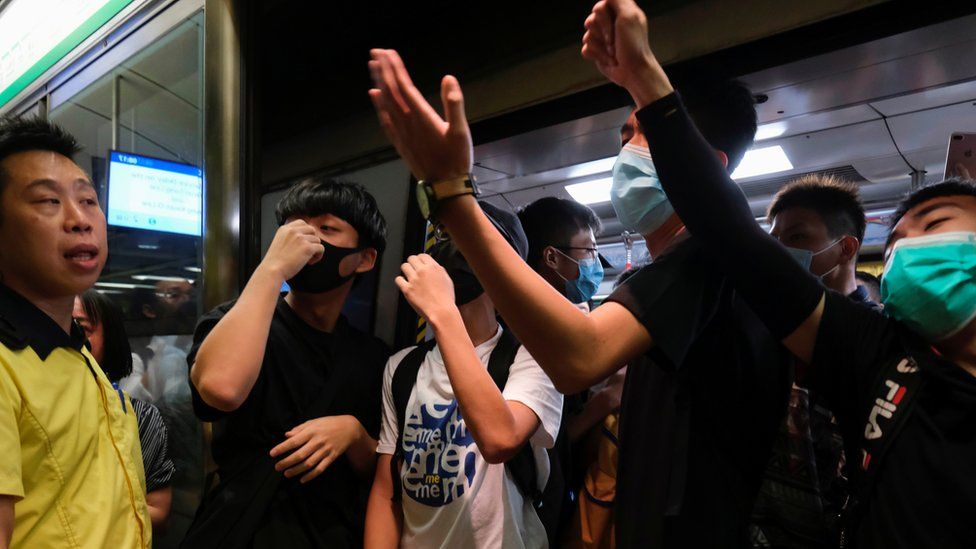 Anti-extradition bill demonstrators block a Mass Transit Railway (MTR) train