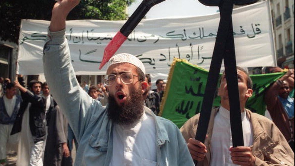An Algerian Islamic Salvation Front (FIS) member brandishes the Koran during a demonstration in Algiers in May 1991.