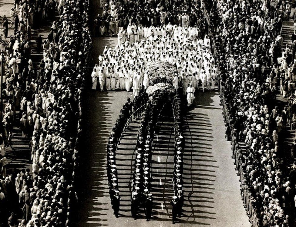 The funeral procession of Indian political and spiritual leader Mahatma Gandhi shows a naval guard escorting the coffin