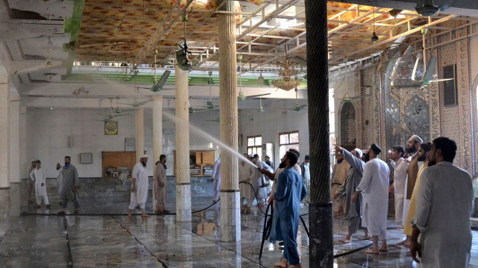 Seminary officials hose down the religious school after the blast on Tuesday
