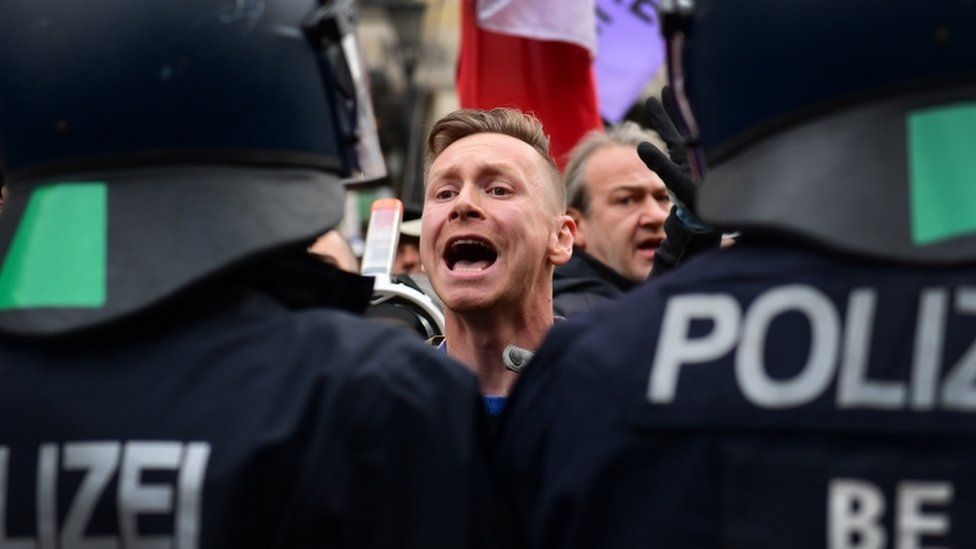 A protester shouts at police officers during a demonstration against German coronavirus restrictions, in Berlin, Germany, 18 November 2020