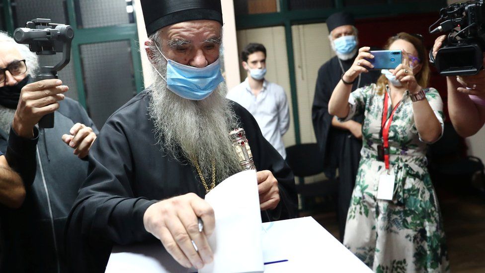 Metropolitan Amfilohije, the Serbian Orthodox Church's top cleric in Montenegro, casts his ballot