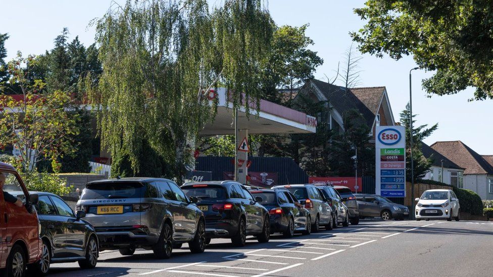 A queue forms for an Esso petrol station in London