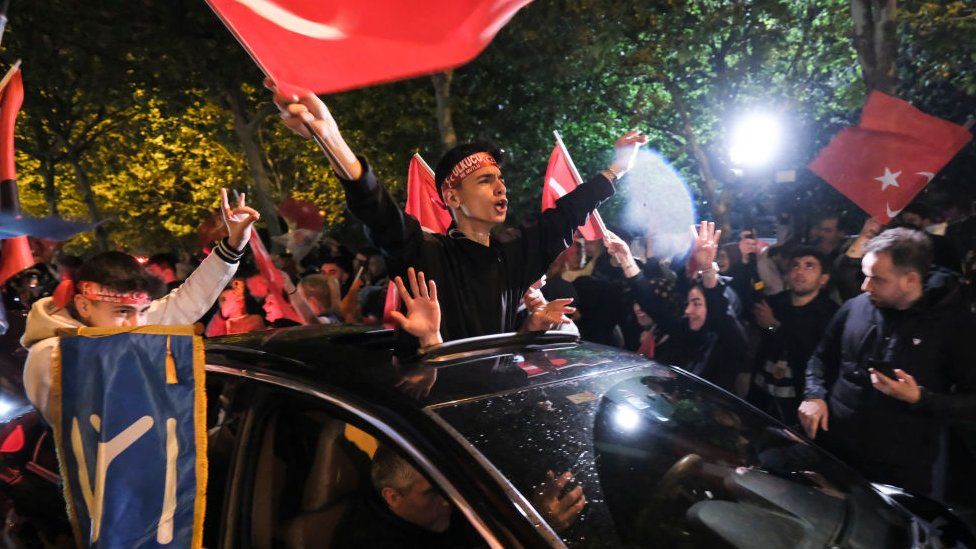 Supporters of President Recep Tayyip Erdogan and the AK Party (AKP) wave flags and party banners in celebration of the election results in Istanbul