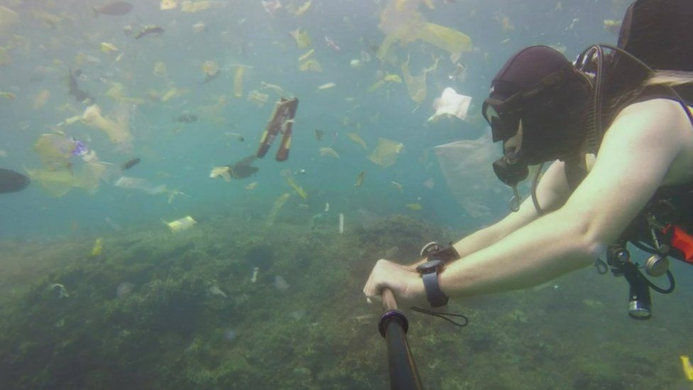 Rich Horner swimming through rubbish off Bali