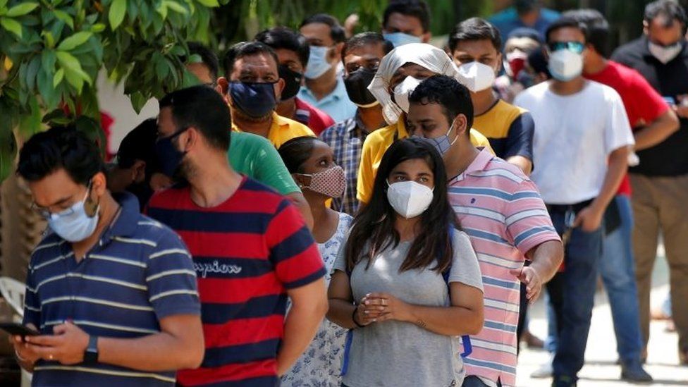 Indians queue for a dose of the coronavirus vaccine