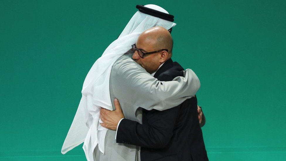 COP28 President Sultan al-Jaber and UNFCCC Executive Secretary Simon Stiell hug.