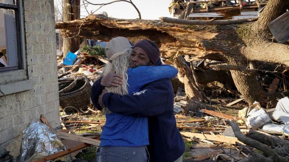 Two friends embrace in Wynne, Arkansas on 1 April