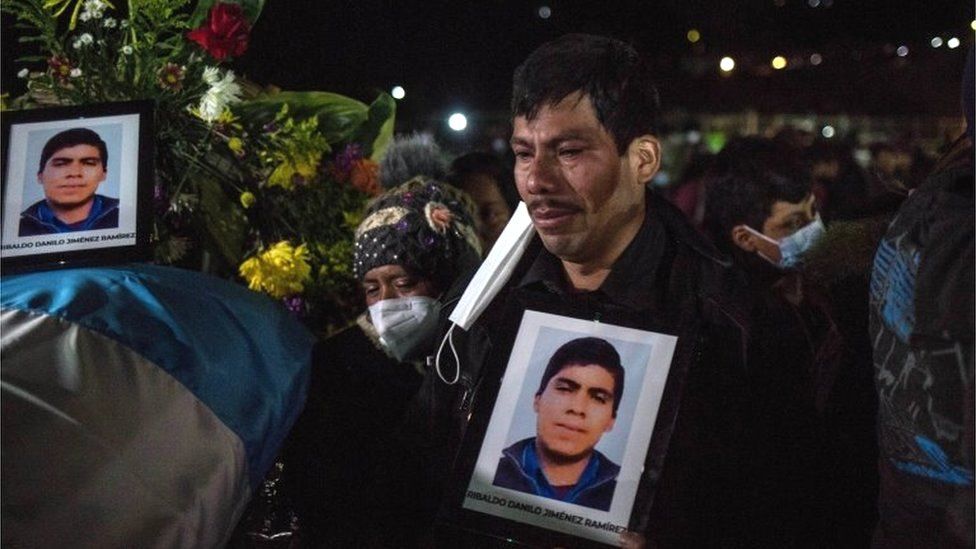 Friends and relatives of the murdered migrants cry as they receive the bodies of their loved ones, in Comitancillo, Guatemala 12 March 2021.