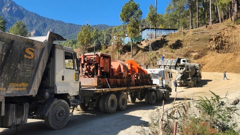 A new auger machine arrives at the site where road workers are trapped in a tunnel after a portion of it collapsed, in Uttarkashi in the northern state of Uttarakhand, India, November 18, 2023.