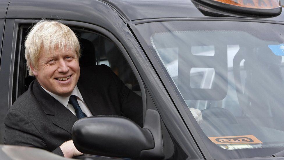 Boris Johnson sitting in a London black cab