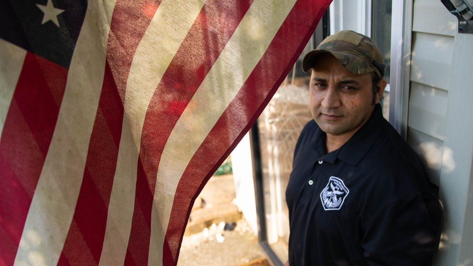 Zia Ghafoori stands in front of his home in North Carolina