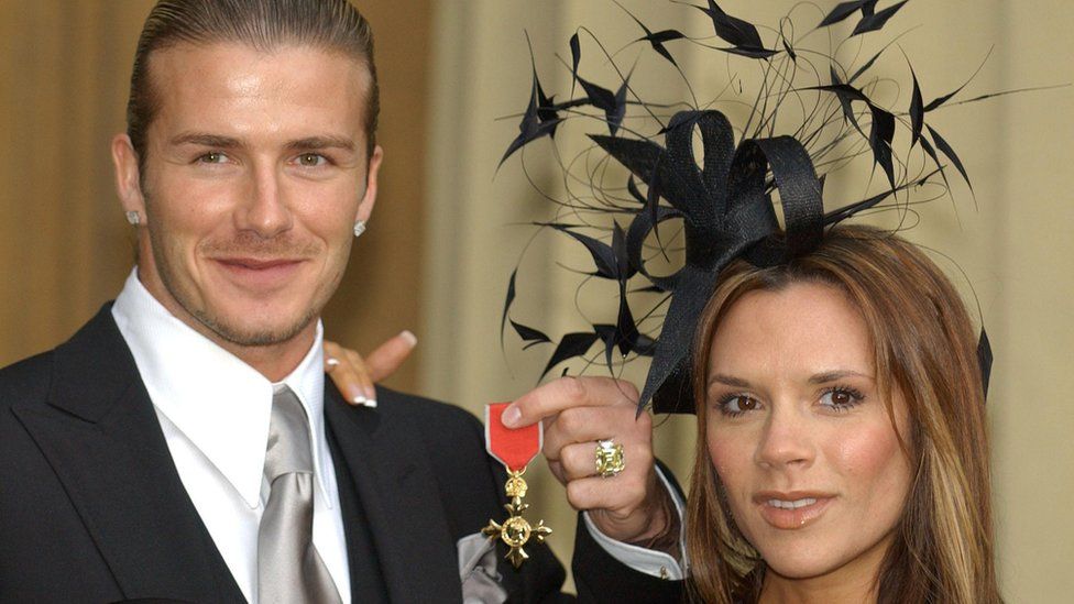 David Beckham with his wife Victoria after being made an OBE in 2003