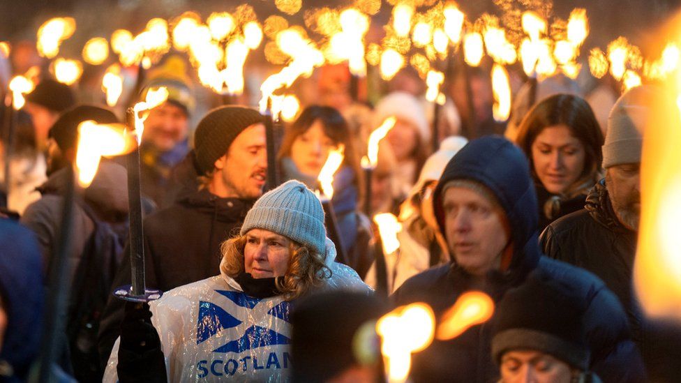 The torchlight procession in Edinburgh has returned after a four-year absence with thousands lining the streets for the spectacular light show