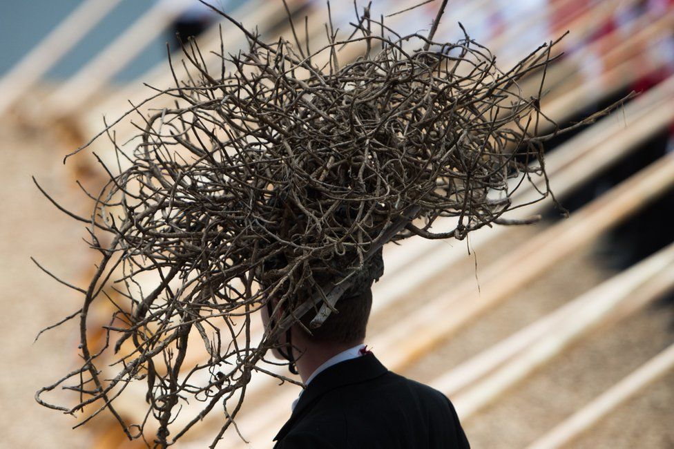A man wearing a headdress made of twigs during the opening ceremony of the Gotthard rail tunnel - 1 June 2016