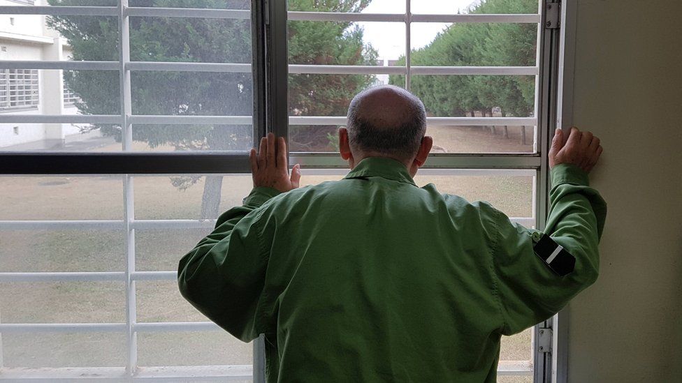 Japanese prisoner looking through bars