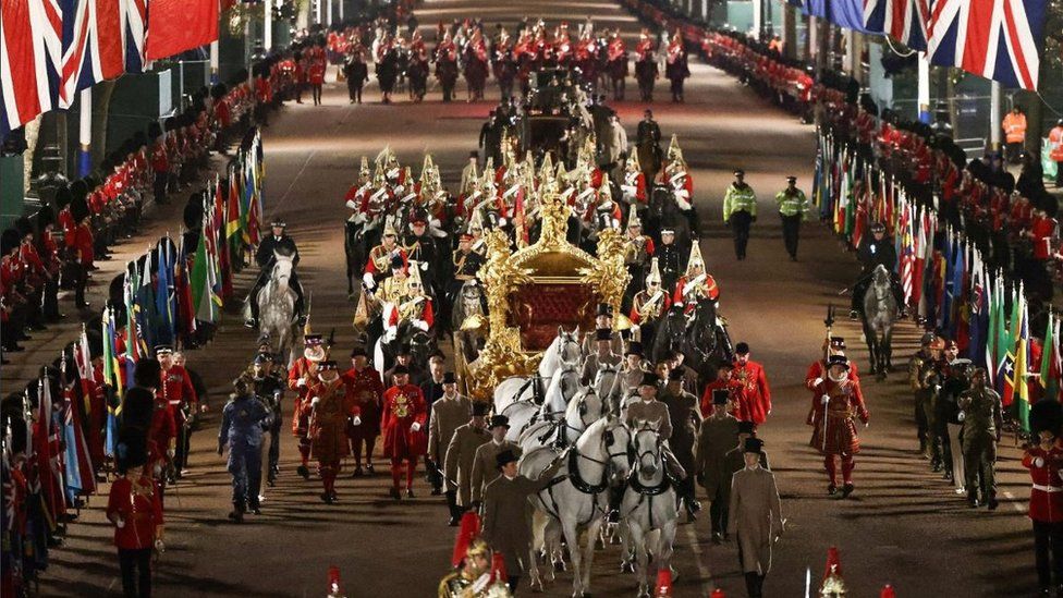 The Gold State Coach is ridden alongside members of the military during a full overnight dress rehearsal of the Coronation Ceremony of Britain’s King Charles and Camilla, Queen Consort in London,