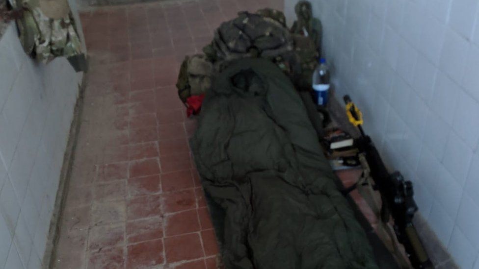 Sleeping bag on a tiled floor next to some visible dust