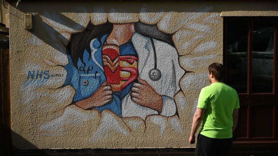 graffiti of NHS worker as superhero