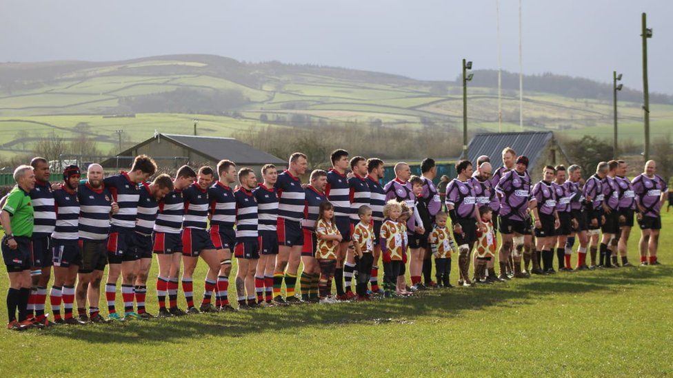 Rugby players lined up in a row