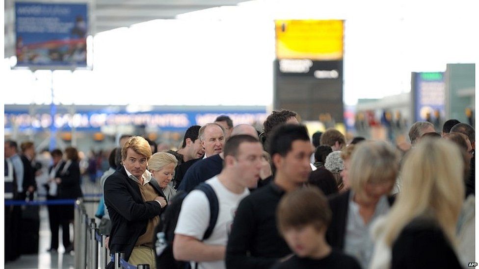 Passengers waiting to check in at Heathrow