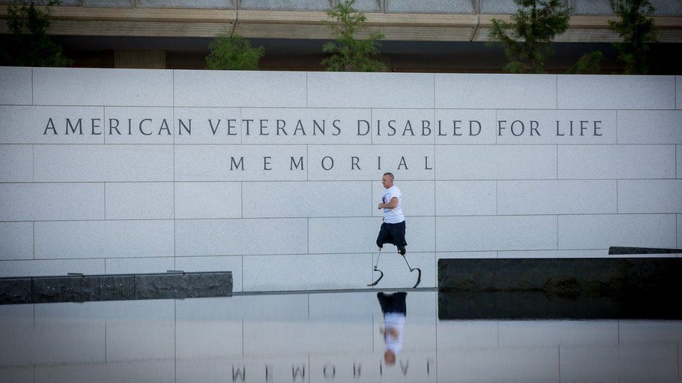 Rob Jones running around a disabled veterans memorial
