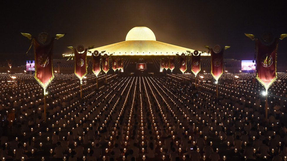Thousands of Buddhist devotees take part in evening prayers by candlelight to mark Makha Bucha Day at Wat Dhammakaya temple, just north of Bangkok, on February 11, 2017.