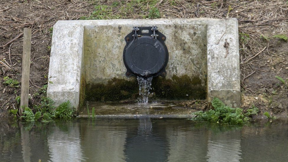 Sewage pipe spills into river