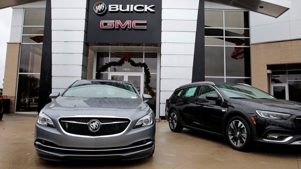 A General Motors Buick LaCrosse vehicle (L) sits on the sales lot of an auto dealership in Ferndale, Michigan, U.S. November 26, 2018.