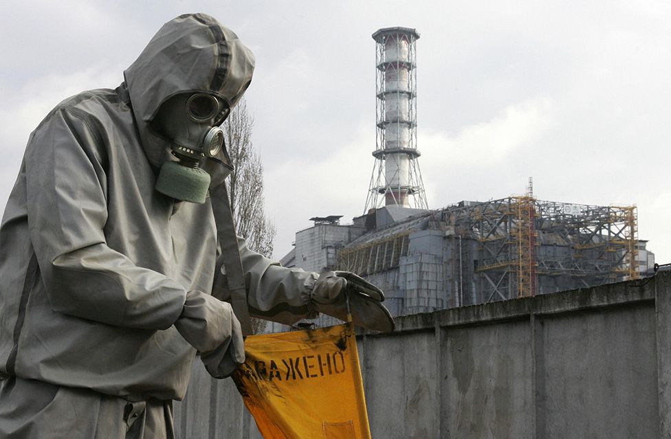 A rescue worker sets flag signalling radioactivity in front of Chernobyl nuclear power plant during a drill organized by Ukraine's Emergency Ministry 08 November 2006.