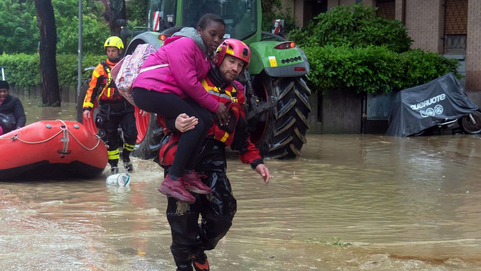 Rescue services carrying a resident in Faenza, near Ravenna