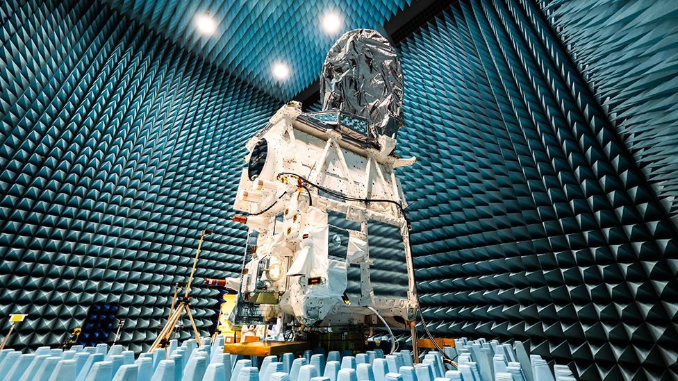 The Earthcare satellite undergoing frequency testing in an anechoic chamber