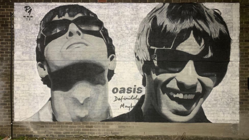 Mural appears on Manchester record shop featured in Oasis track - BBC News