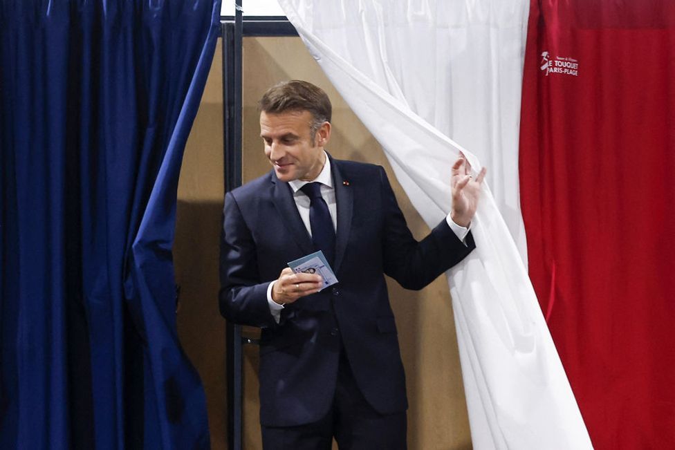 France's President Emmanuel Macron exits a polling boothat a polling station in Le Touquet, northern France 