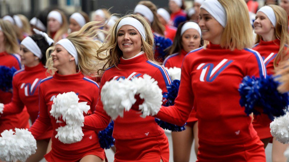 Cheerleaders dance through the streets of London on Sunday
