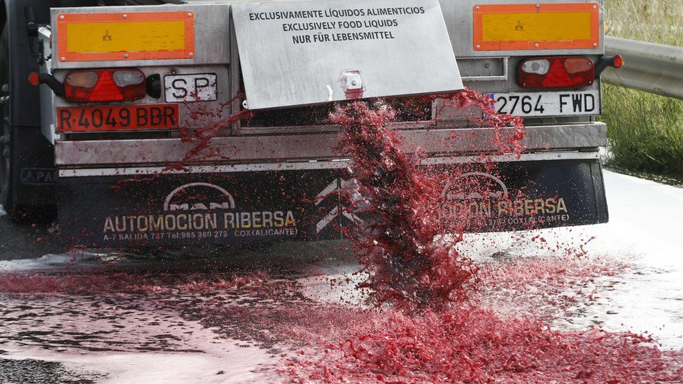 Wine flows from the tap of a Spanish lorry