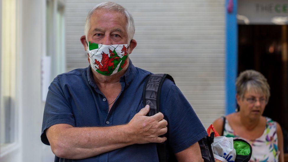 Man in Welsh flag facemask