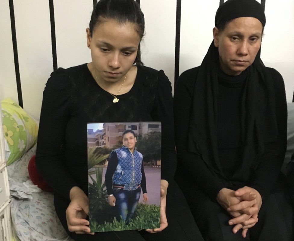 Marian Abdel Malak (left) holds picture of her brother, Bishoy