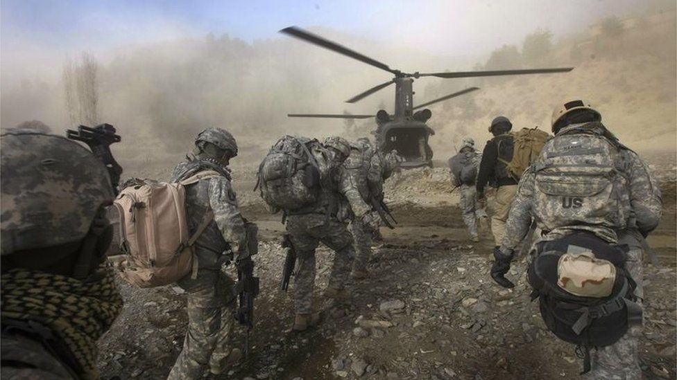 In this picture taken on November 22, 2008, US Army soldiers from 2-506 Infantry 101st Airborne Division and Afghan National Policemen and Army load onto a UH-47 Chinook helicopter landing to pick them up during day three of Operation Shir Pacha into the Derezda Valley in the rugged Spira mountains in Khost province, along the Afghan-Pakistan Border, directly across the border from Pakistan's lawless Waziristan region.