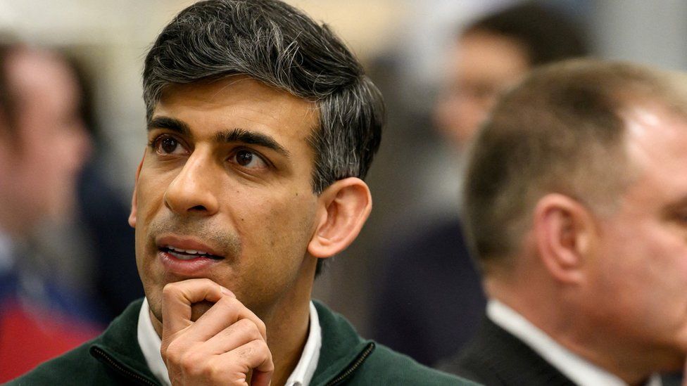 Rishi Sunak listens to information on engine development during a visit to the Rolls-Royce manufacturing facility in Bristol