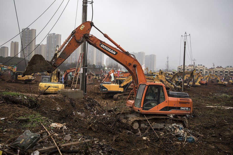 A digger is seen on the construction site of Huoshenshan hospital