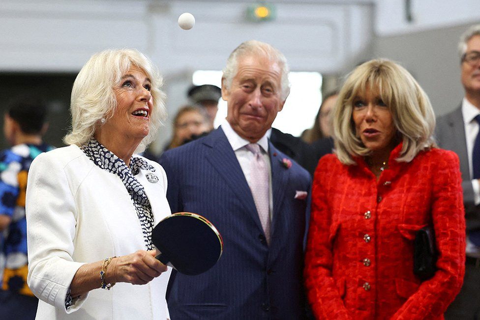 Queen Camilla plays table tennis next to King Charles and Brigitte Macron