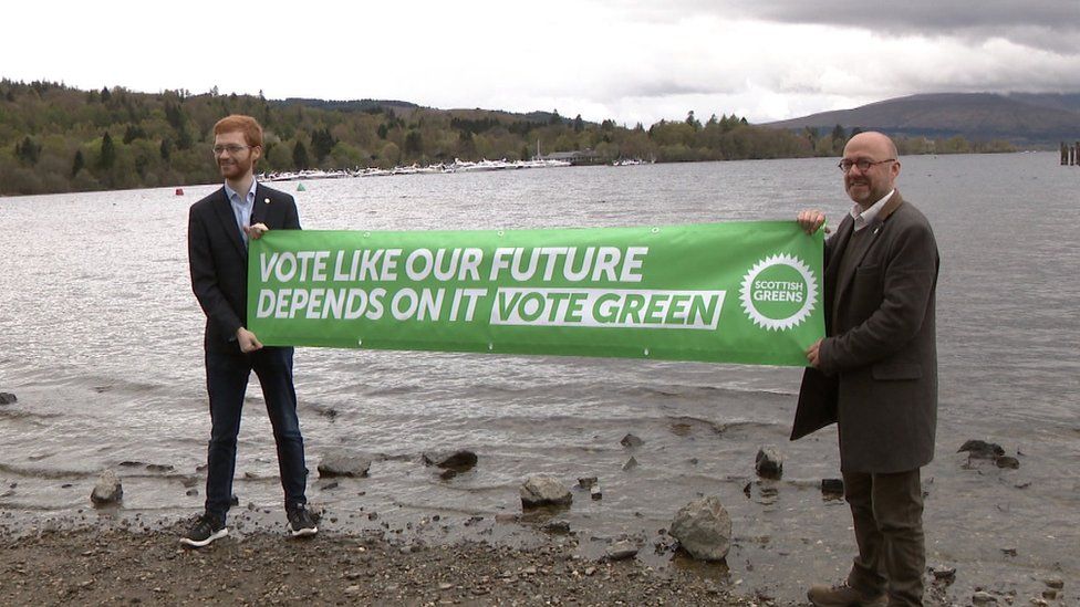 Scottish Greens co-leader Patrick Harvie and Ross Greer hold a banner saying "Vote like our future depends on it, vote Green".