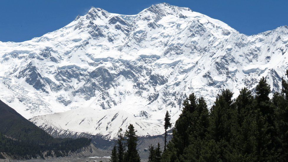 A tourist enjoys the view of Nanga Parbat, Pakistan's second-highest mountain.